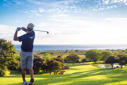 Golfer hitting the ball on a golf course