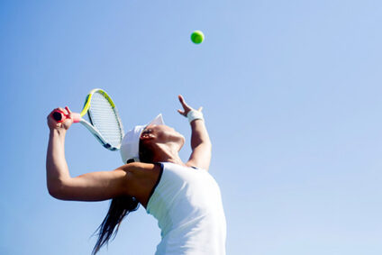 Tennis player taking a serve